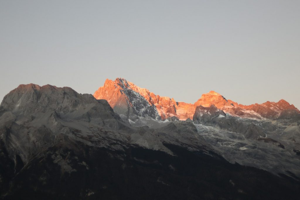 a view of the top of a mountain at sunset