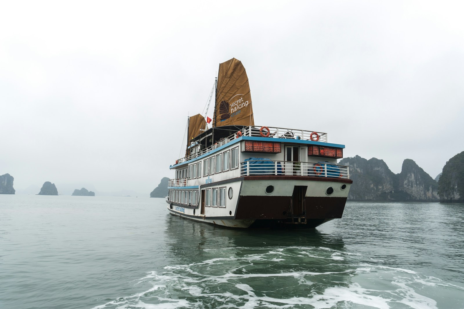 A large boat floating on top of a body of water