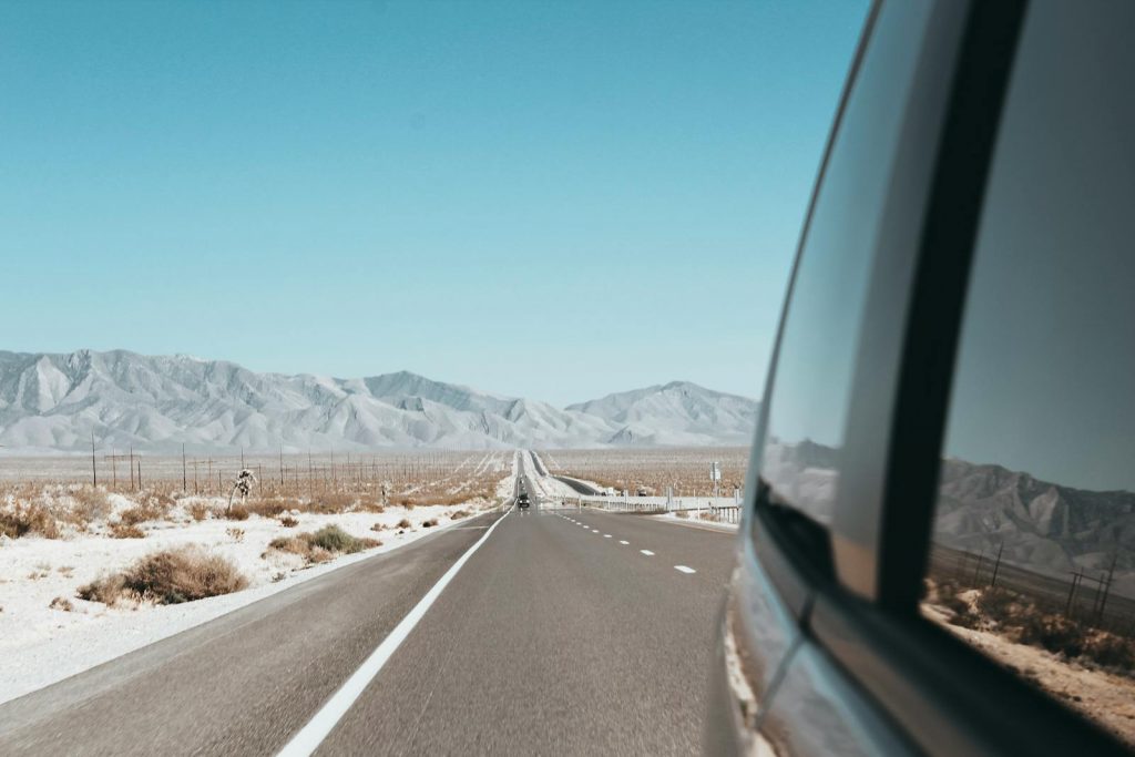 Explore the vast Arizona desert landscape with mountains and an endless road. Ideal for travel enthusiasts.