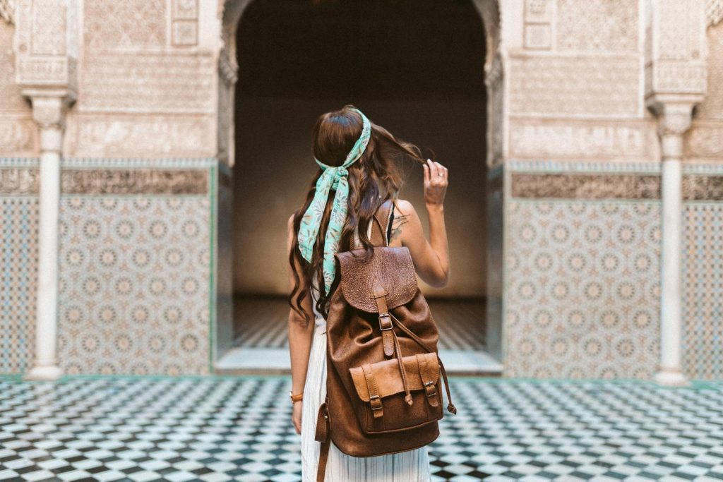 Frau in Marrakesch mit Rucksack in der Medina unterwegs