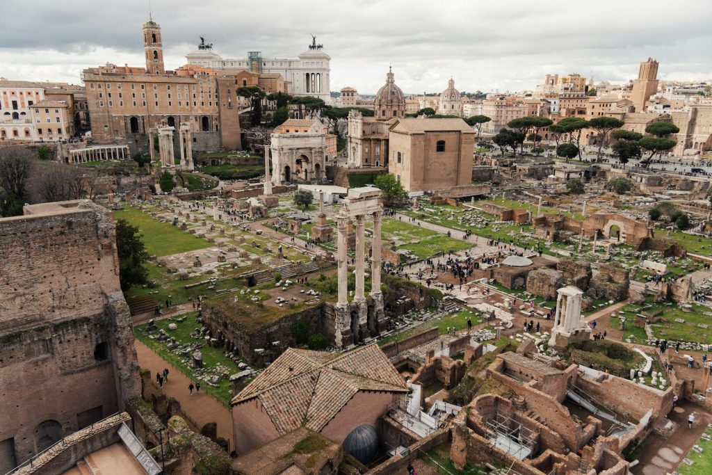 Explore the majestic ruins of the Roman Forum from above, showcasing ancient history and iconic Roman architecture.