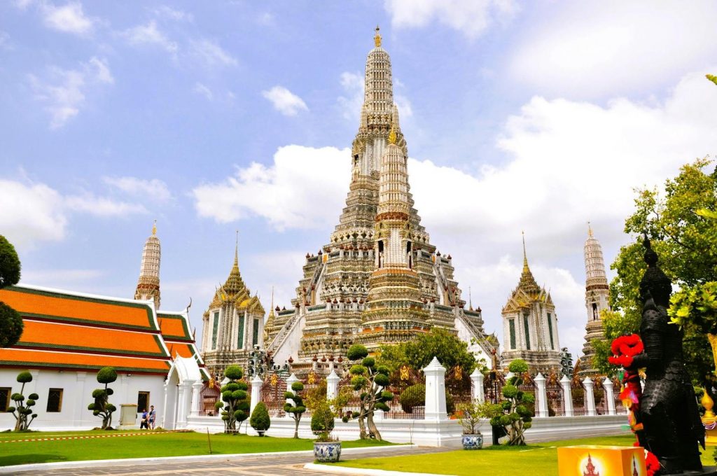 Beautiful architectural view of Wat Arun temple against blue sky in Bangkok, Thailand.