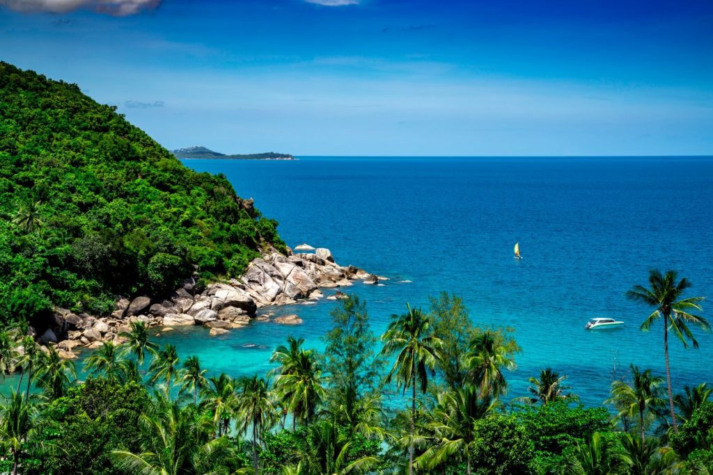 Breathtaking view of Koh Samui's tropical coastline with lush greenery and azure sea.